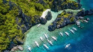 Aerial,Drone,View,Of,Boats,Over,A,Tropical,Coral,Reef